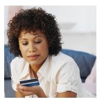 Photo of woman looking at credit card | BEBdata Bankruptcy Data Blog